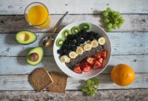 Fresh Organic Superfoods on Table (Lime, Avocado, Greens)